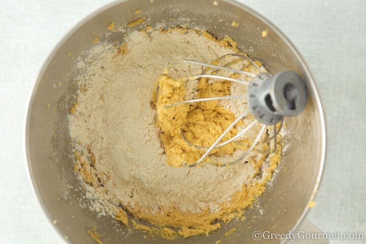 adding flour to cookie dough.