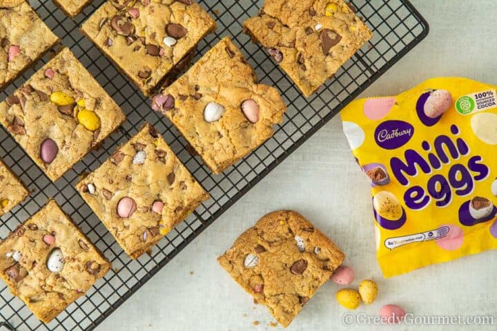 mini egg cookie bars laid out on a cooling tray.