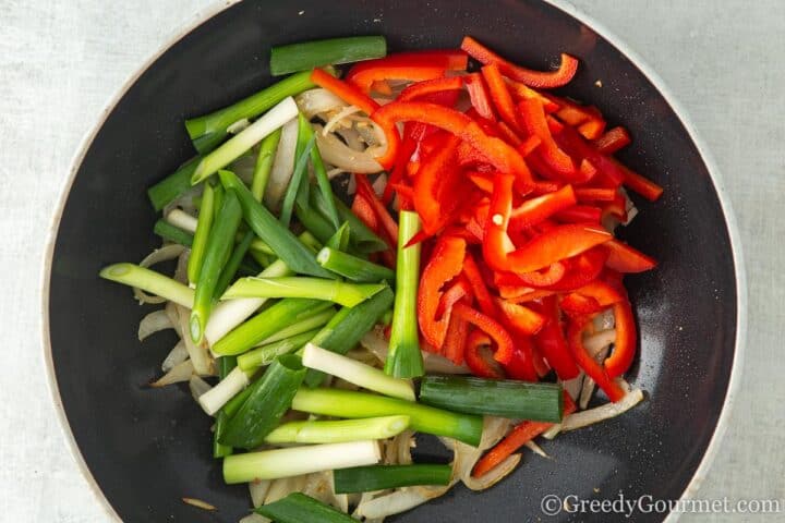 Frying peppers and spring onions.