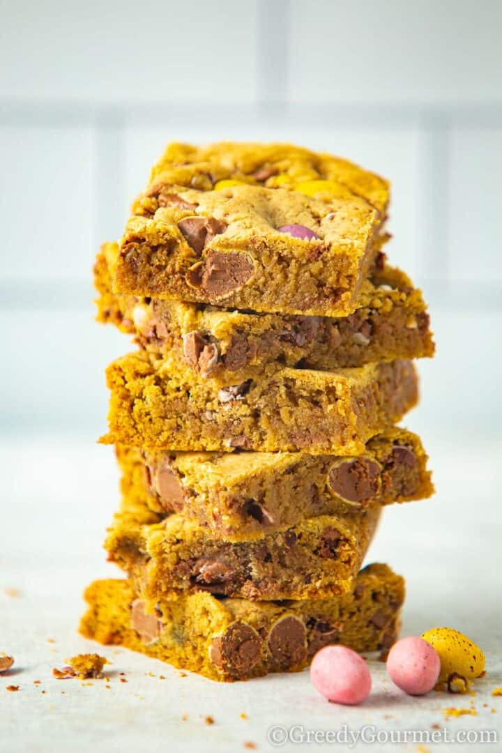 mini egg cookie bars stacked on top of each other.