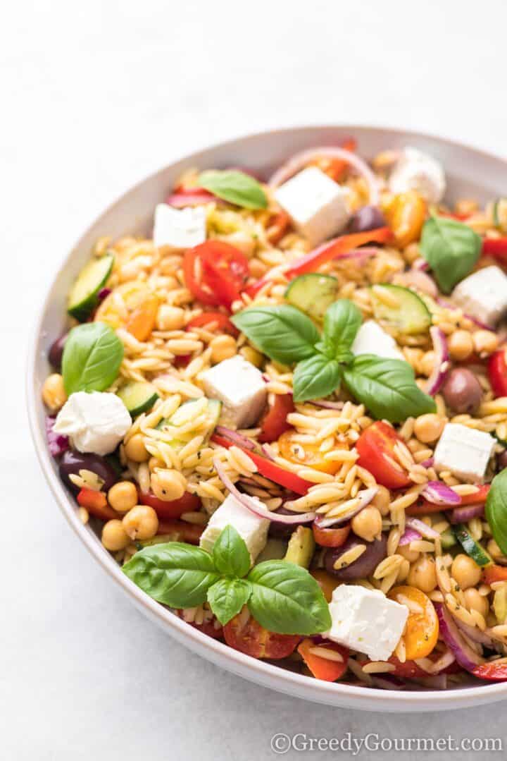 Mediterranean Orzo Salad in a white bowl.