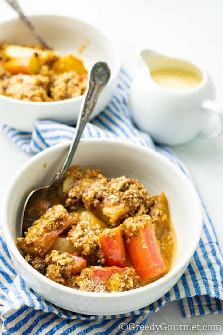 eating rhubarb and pear crumble with a spoon.