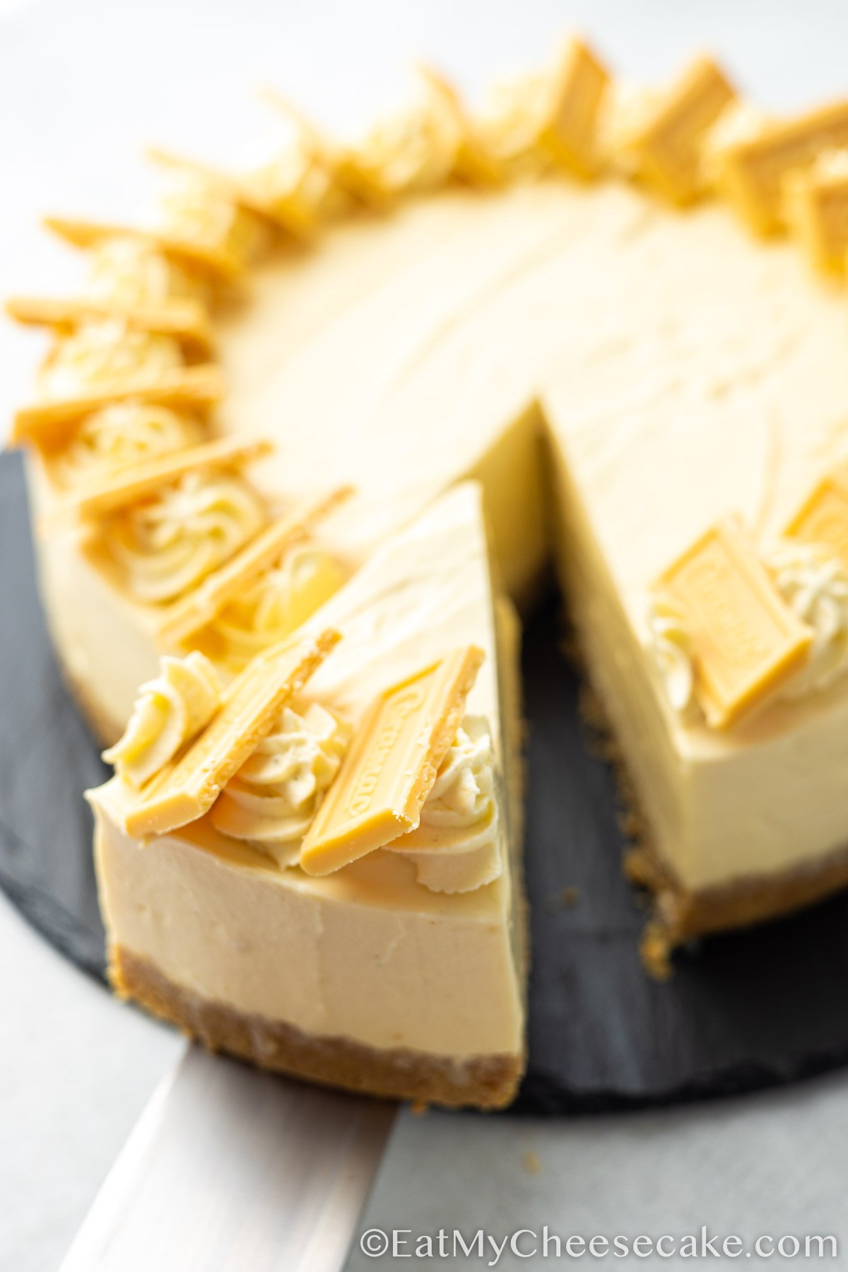 cutting a slice of caramac cheesecake.