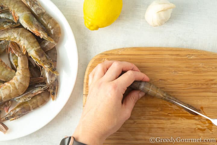 slicing a prawn across its back.