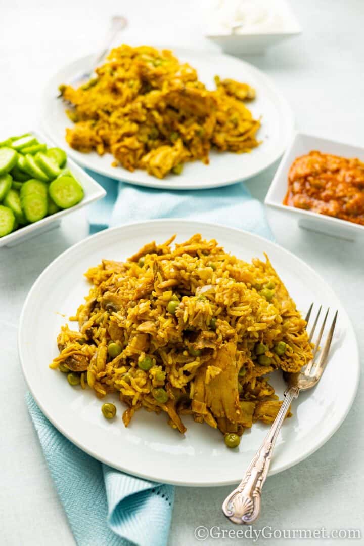 biryani served on a white plate.