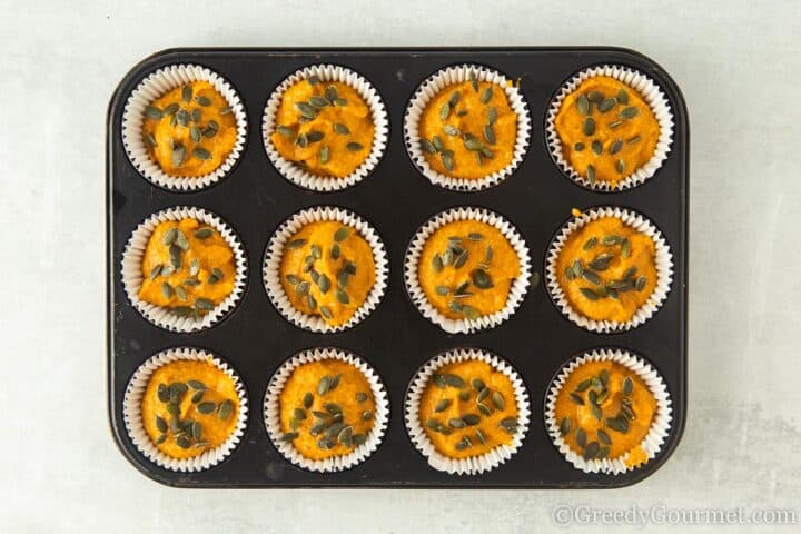 cooked protein muffins topped with pumpkin seeds.
