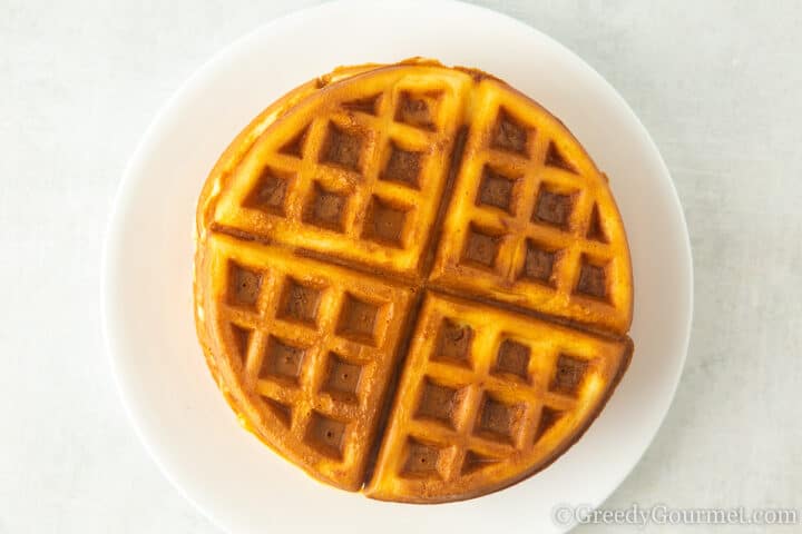 Stack of waffles on a plate.