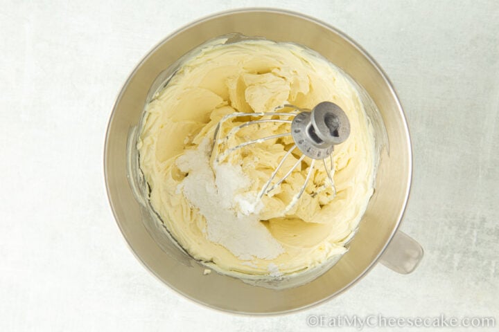 adding sugar to whipped cream.