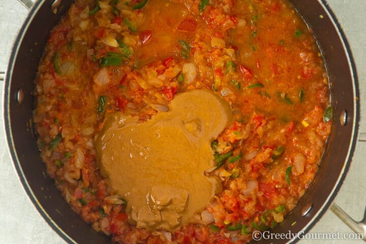add peanut butter to pan of onion and tomato.