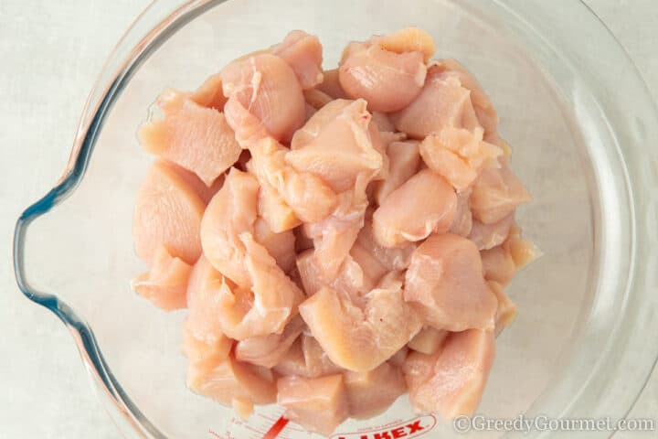 chopped chicken breast in a glass bowl.