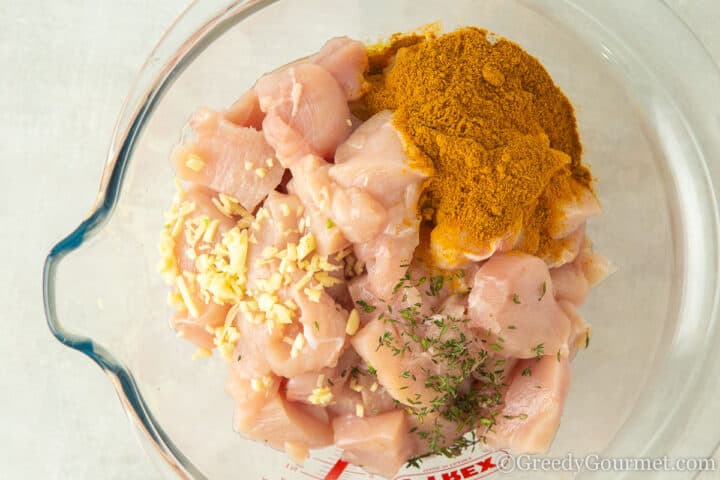 marinating ingredients with chopped chicken