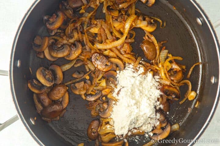 stir in flour with mushrooms and onion.