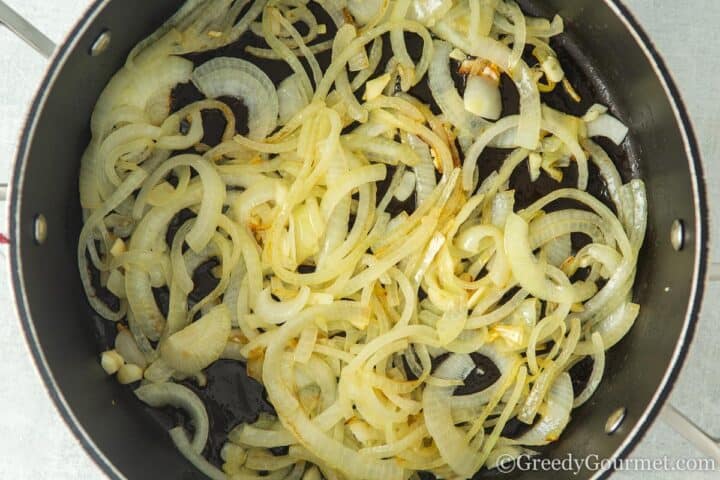 softened onions in a frying pan.