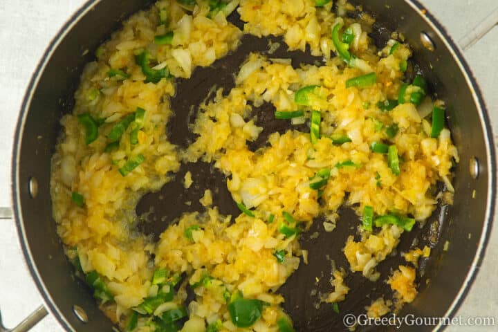 softening onions in a pan.