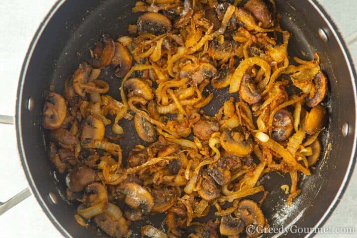 add mushrooms to softened onions in the frying pan.