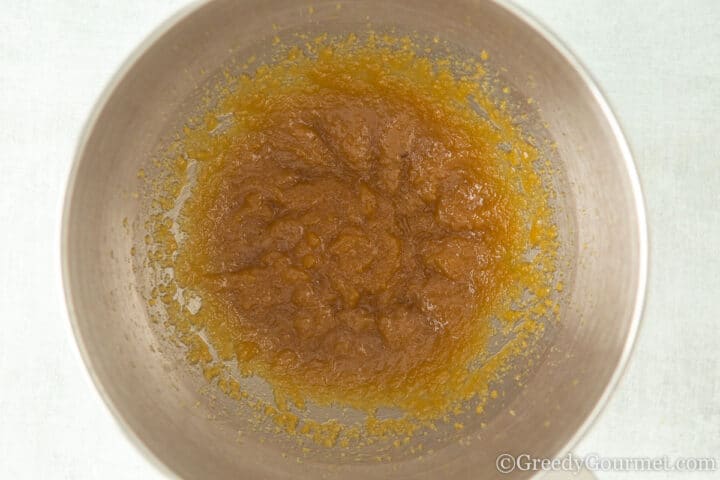sugar and butter mix in a metal mixing bowl.