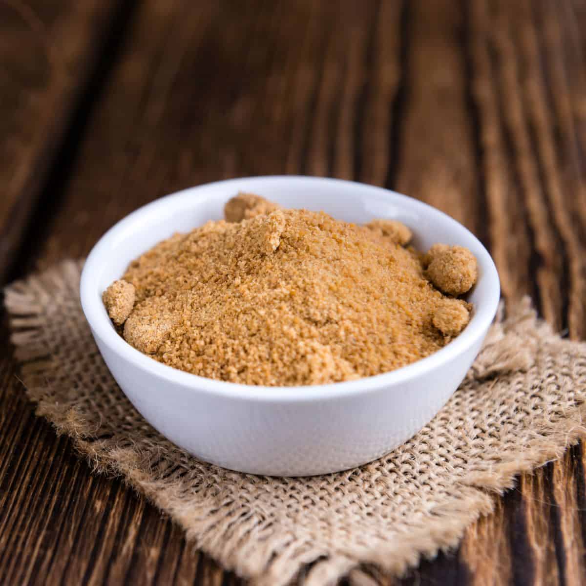 coconut sugar substitutes featured image, bowl of brown coloured sugar.