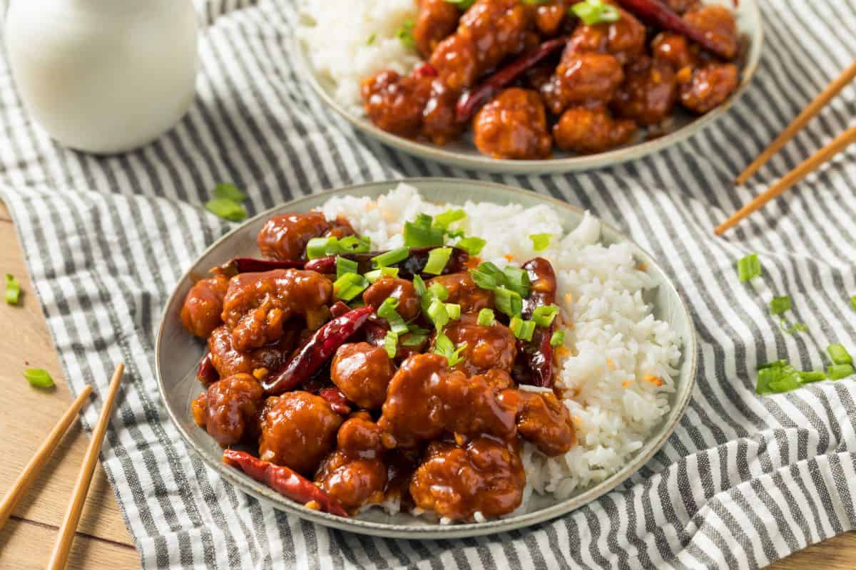 general tso chicken and rice on a grey plate.