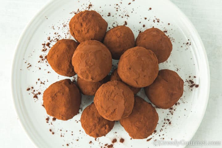 chocolate mochi balls piled on a plate.