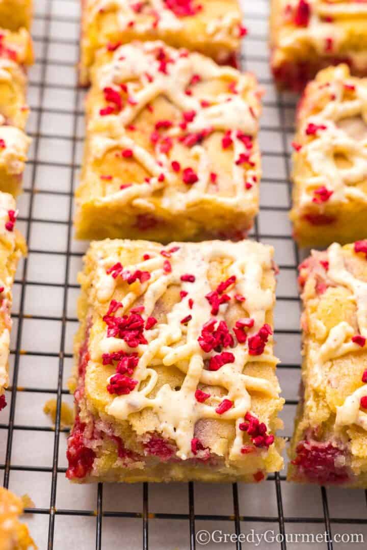 raspberry blondies on a cooling rack.