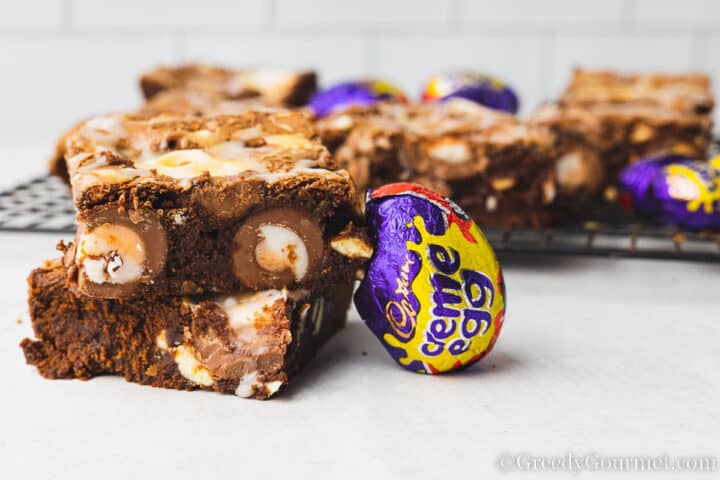 wrapped creme egg leaning against a brownie.