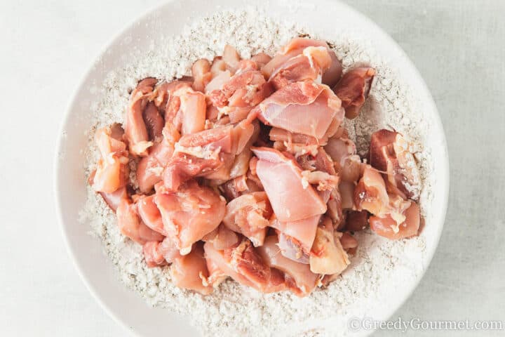 raw chicken on top of flour.