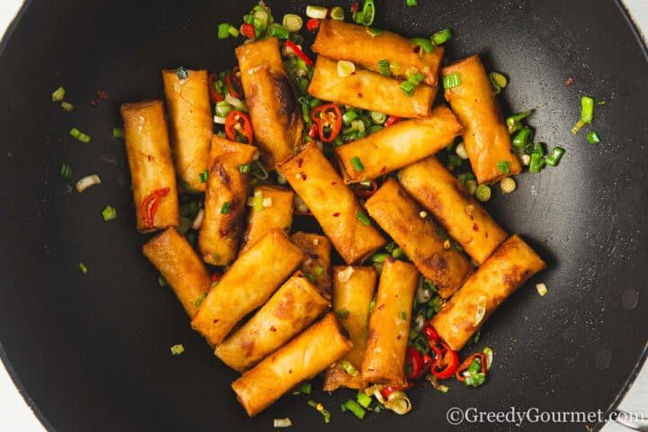 spring rolls and vegetables in a pan.