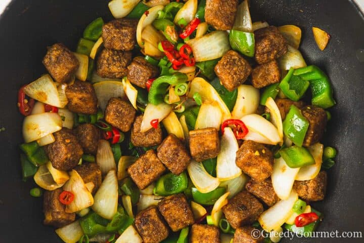 fried salt and pepper tofu with pepper and onion.