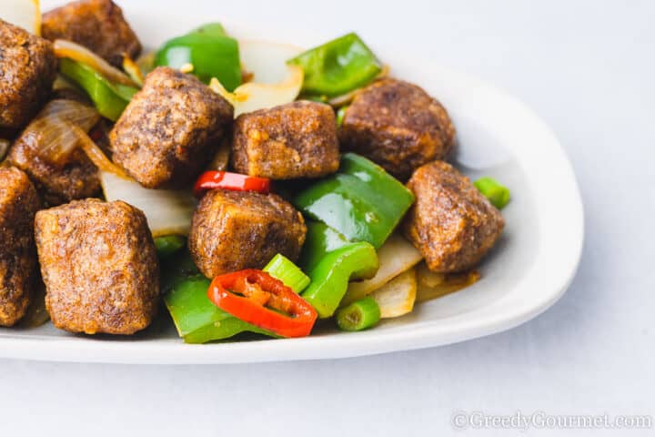 salt and pepper tofu on an oblong plate.