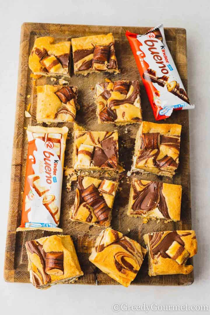 kinder blondie squares on a wooden serving board.