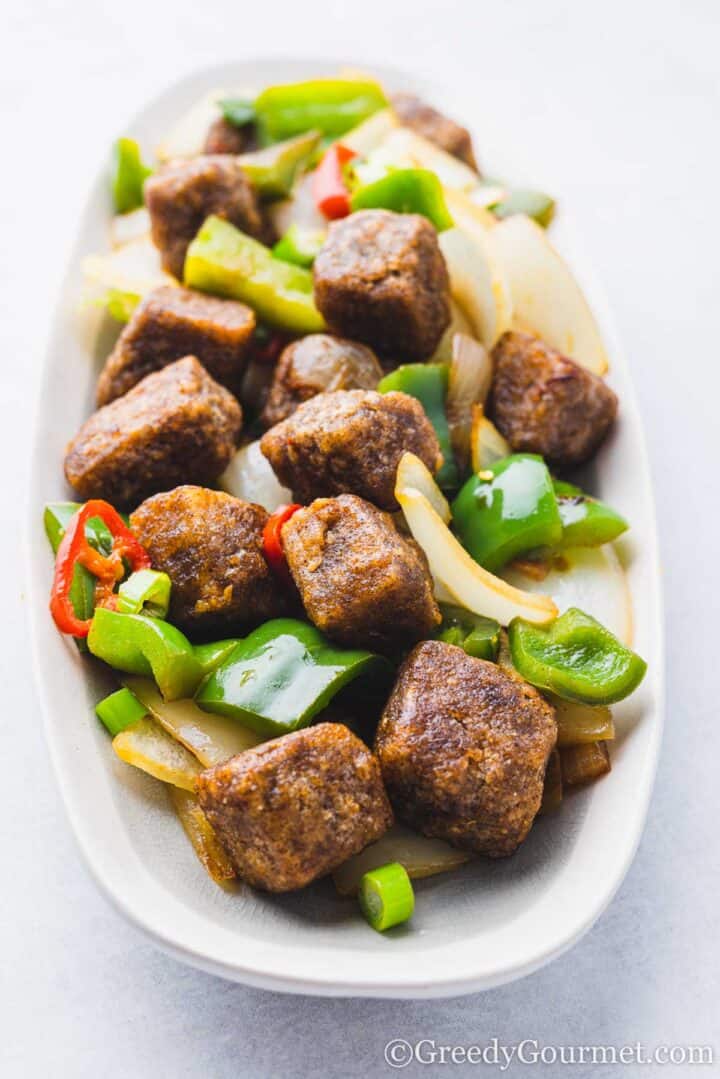 salt and pepper tofu on an oblong plate.