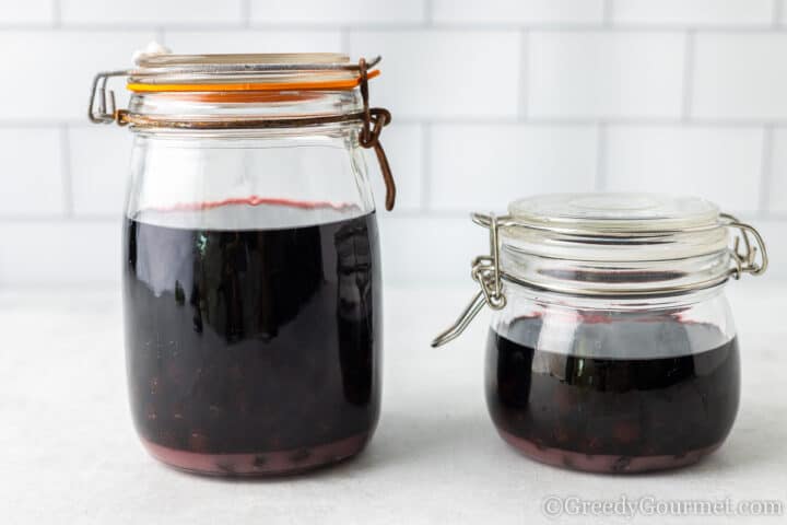 steeping sloe berries in a jar.