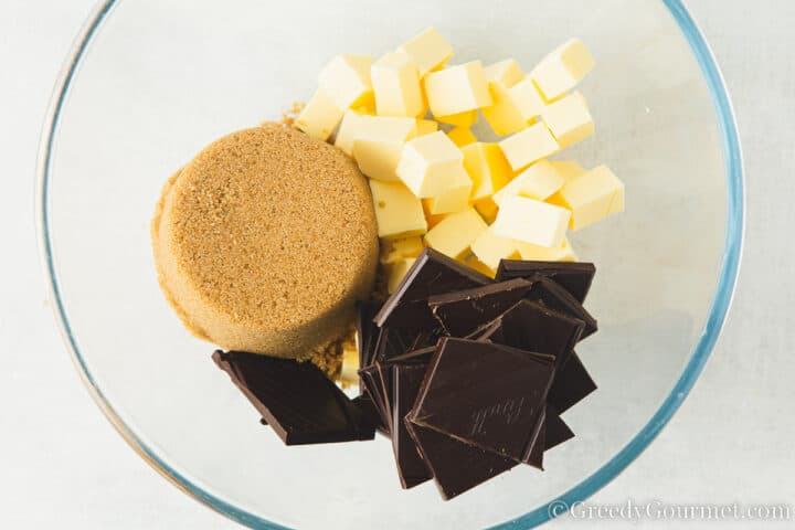 sugar, butter and chocolate in a glass bowl.