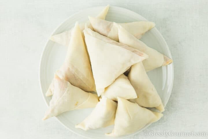 pile of folded samosas.