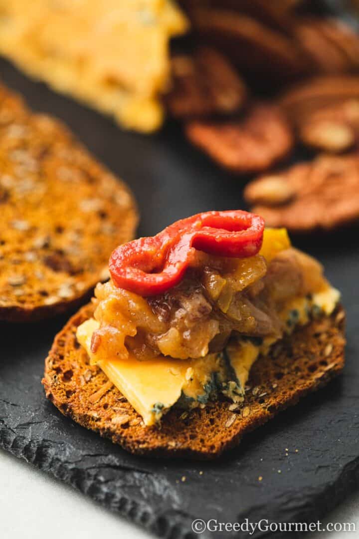 cracker with cheese, chutney and chili.