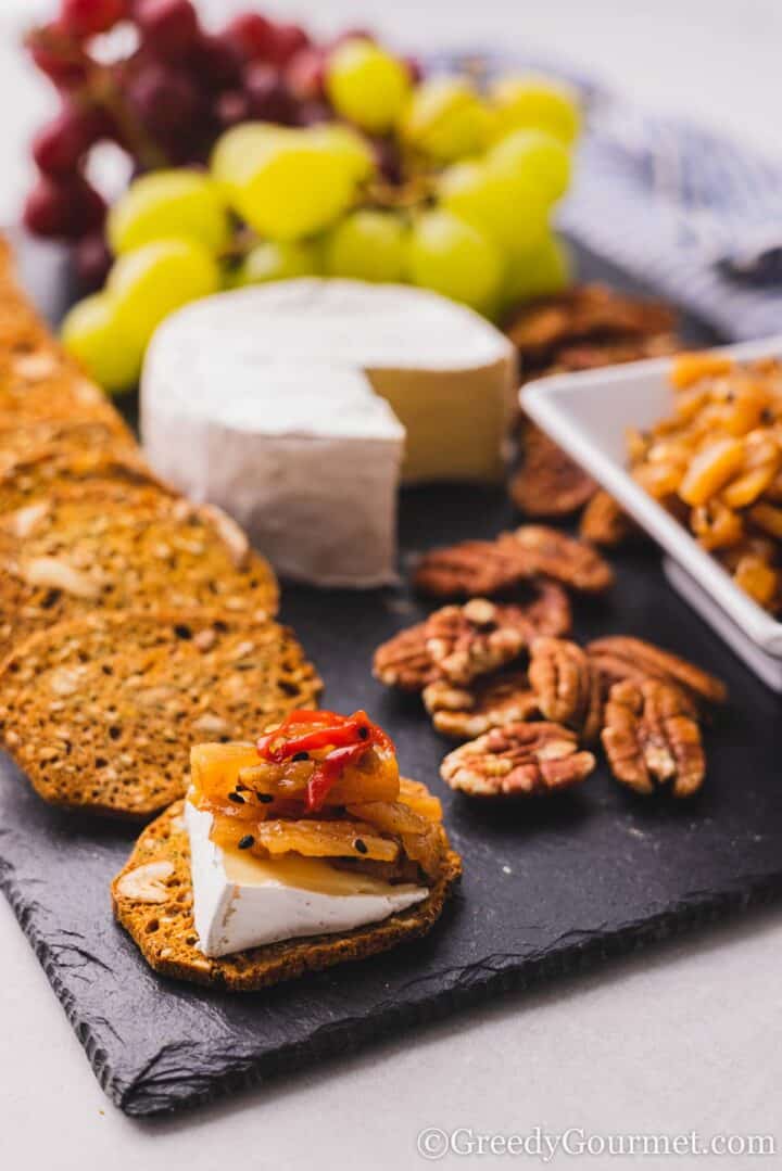 cracker with chutney, cheese and chili.