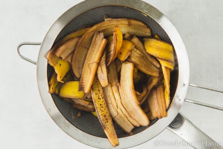 draining boiled banana peels.