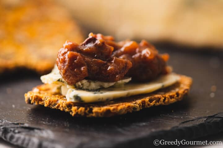 banana chutney on a cracker with blue cheese.