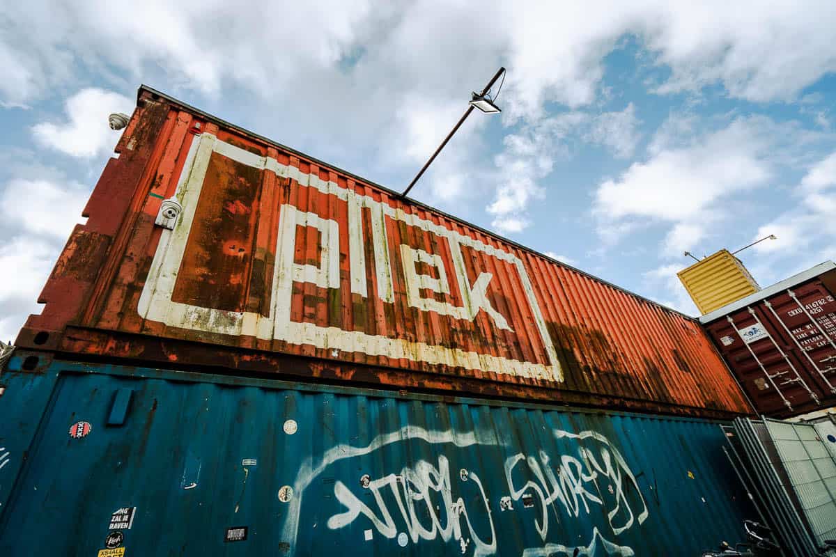 Containers with the entrance sign of restaurant Pllek at NDSM.