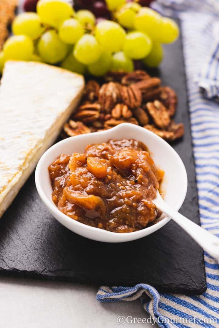 small bowl of chutney of a cheese board.