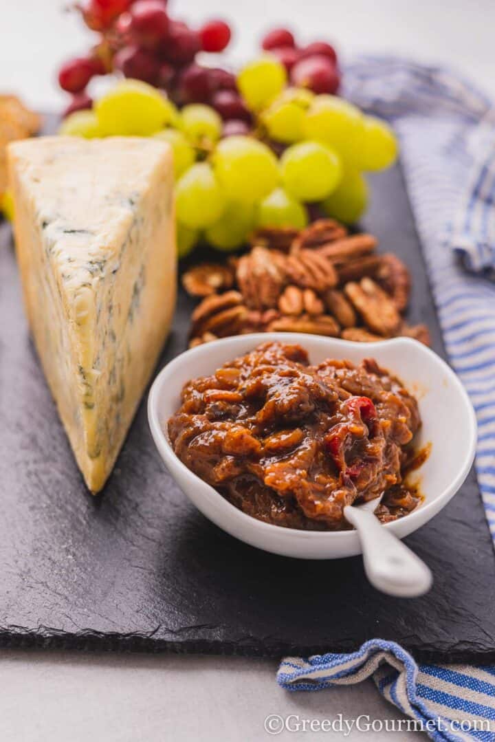 small bowl of banana chutney on a cheese board.