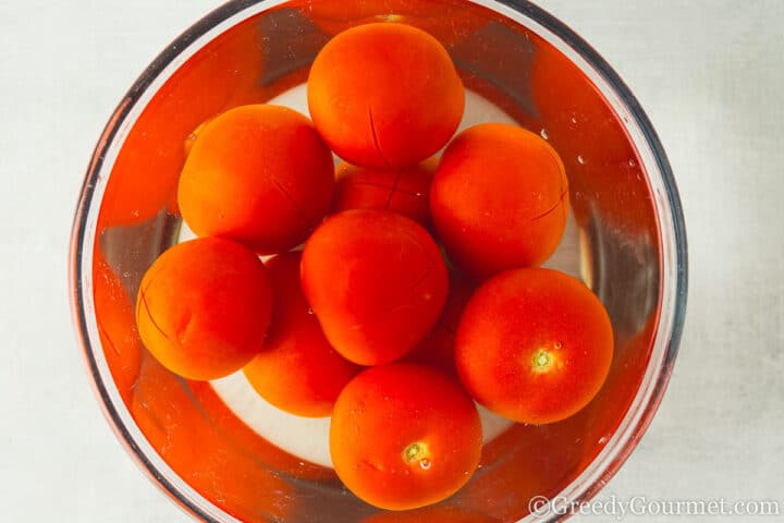 soaking tomatoes in a bowl.