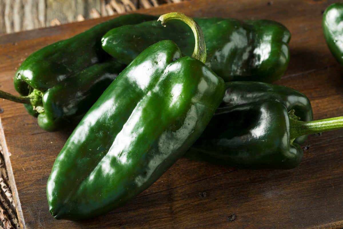 Poblano peppers on a chopping board.