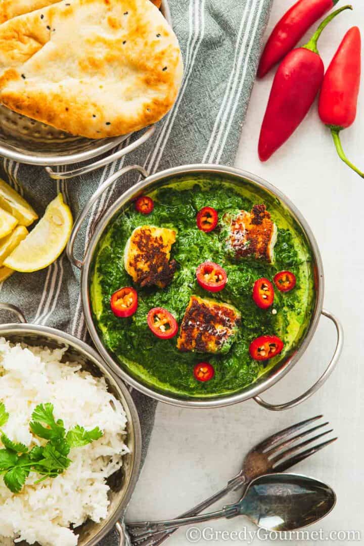 saag paneer served with a dish of rice.