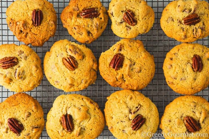 Cooked pecan cookies on a cooling rack.