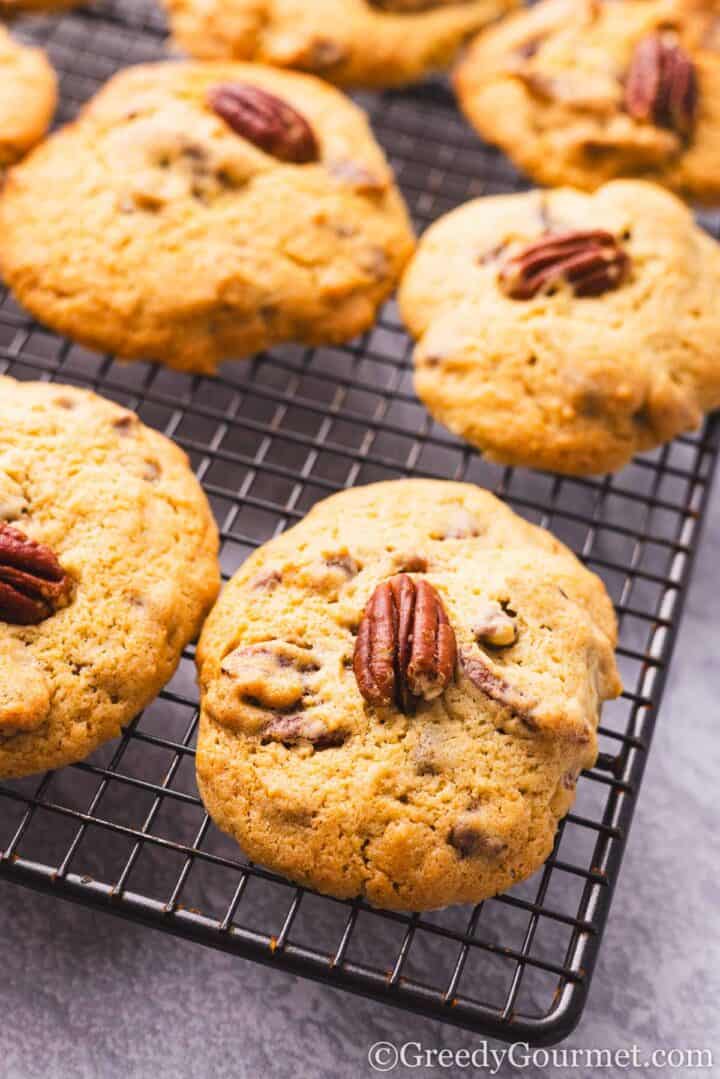 Cooked pecan cookies on a cooling rack.