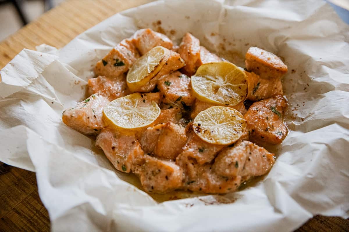 Air fryer salmon bites on a piece of paper.