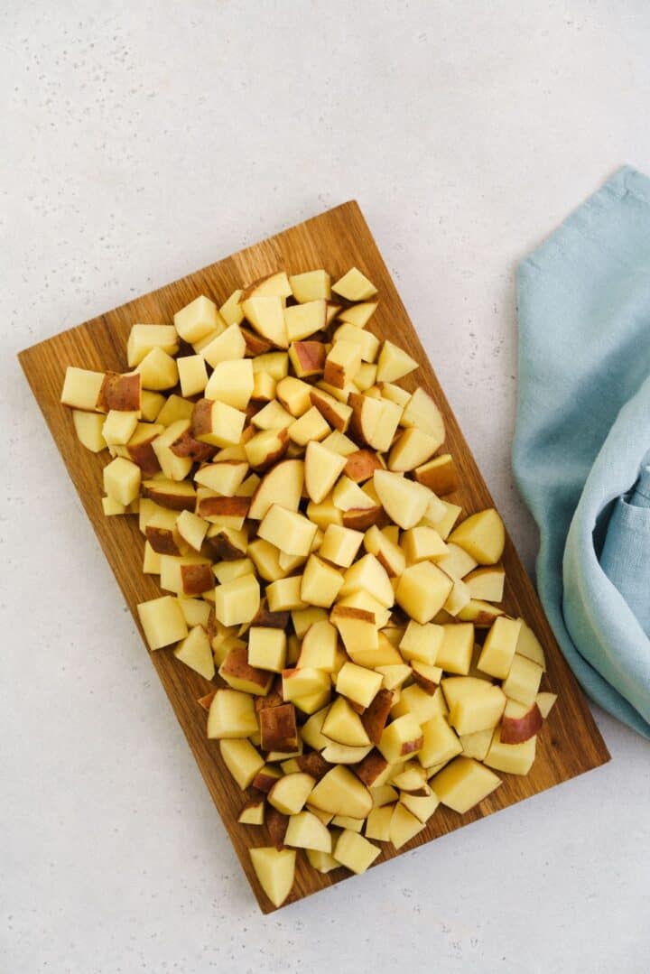 cutting board with cubed potatoes.