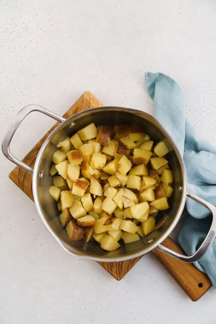 Cooked potatoes with butter in a pan.
