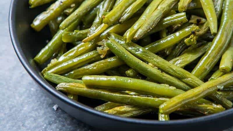 Garlic Roasted Green beans in a black bowl